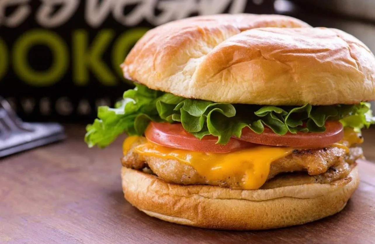 Vegan burger with lettuce, tomato and melted cheese