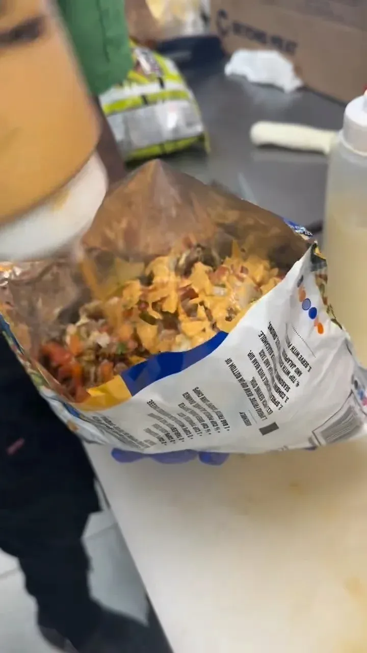 Loaded walking taco being prepared